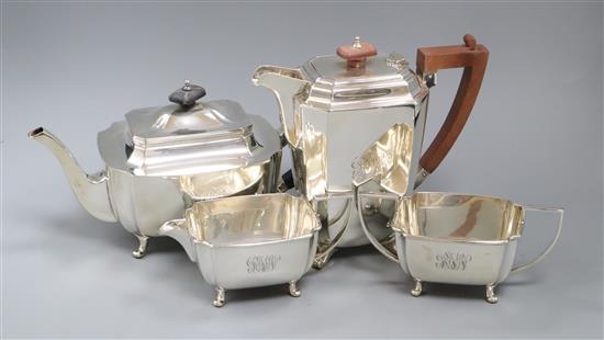 A George VI three piece silver tea set, Sheffield, 1946 and similar silver hot water pot, gross 61.5 oz.
